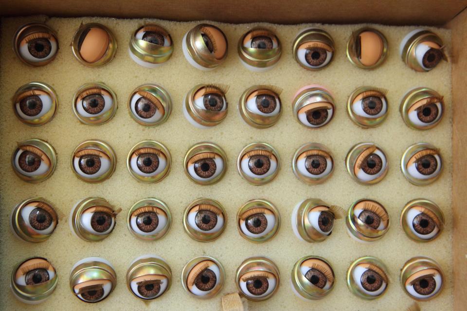  A case of spare glass eyes stares out at visitors to the world's oldest doll hospital