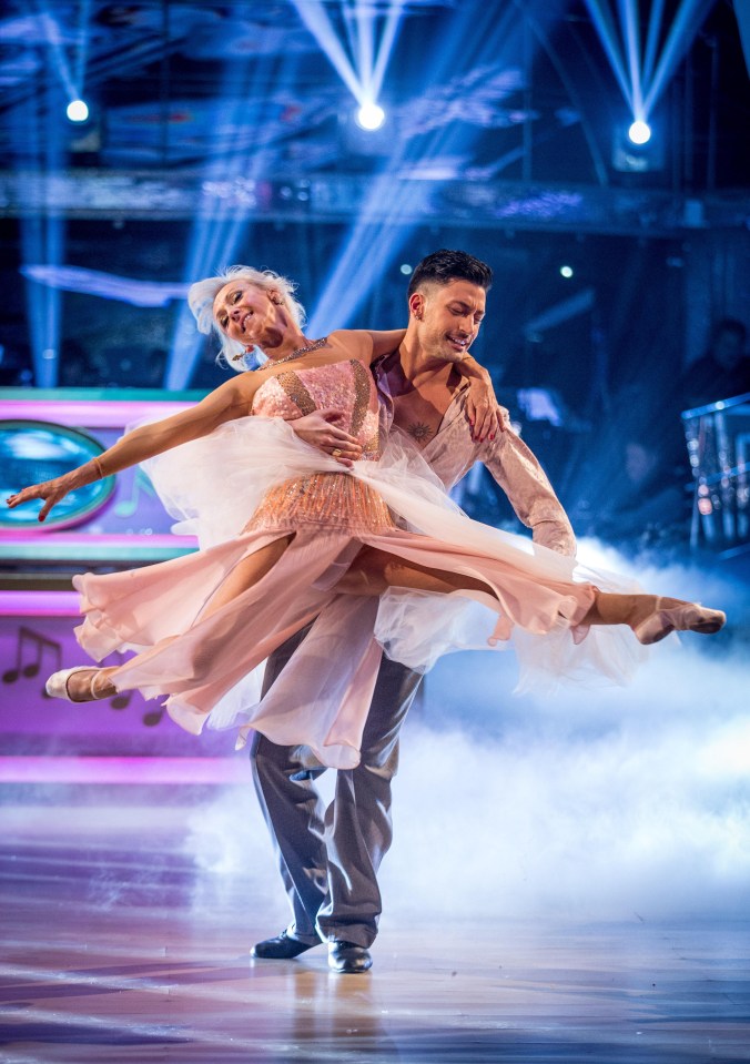 a man and a woman are dancing on a stage