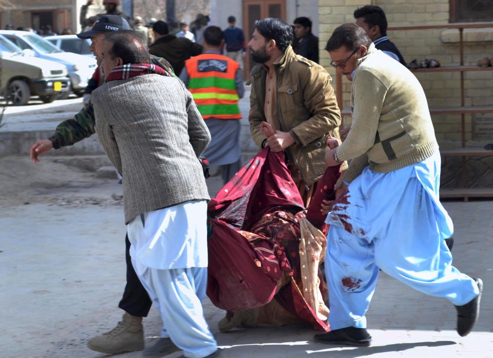  A body is carried away from the murdeorus attack