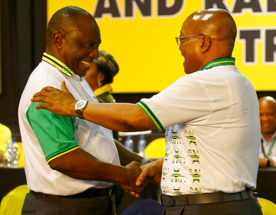 Cyril Ramaphosa (left) celebrates with outgoing president, Jacob Zuma