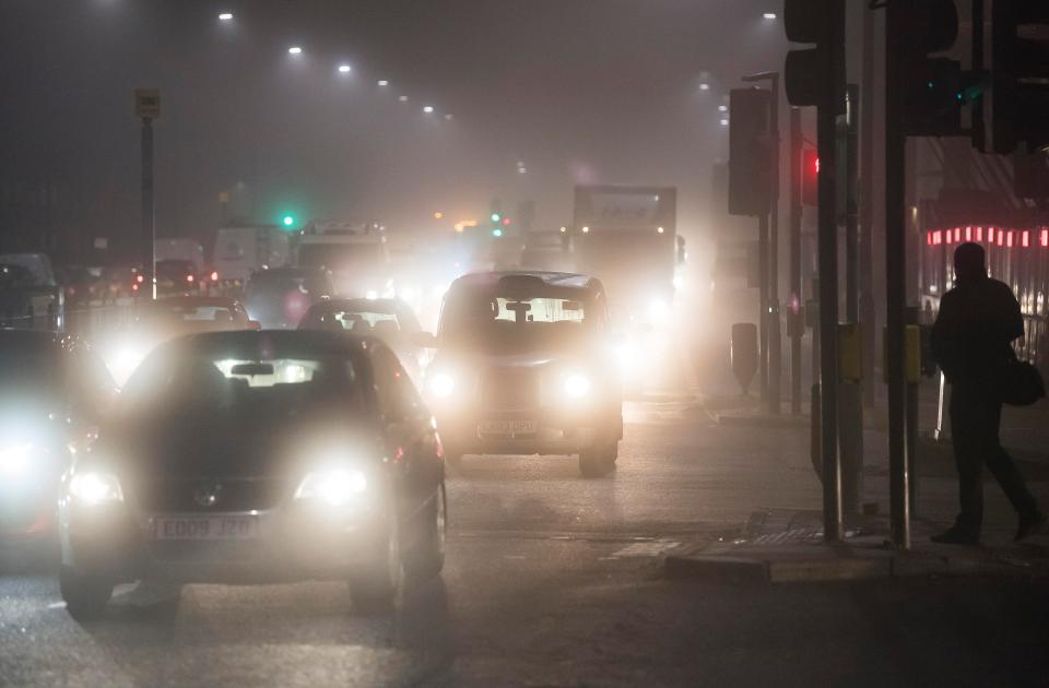  Commuters make their way through heavy fog on the A40 in West London