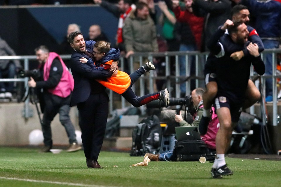 Bristol City manager Lee Johnson spins a ball boy around at the final whistle