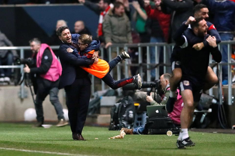  Bristol City manager Lee Johnson spins a ball boy around at the final whistle