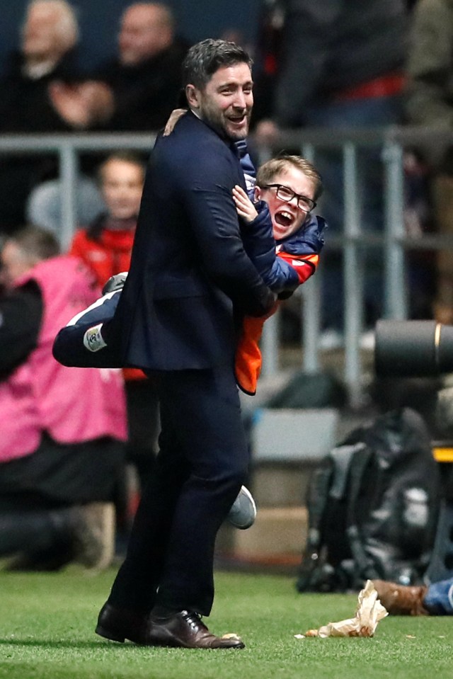 Bristol City manager Lee Johnson hugs a ball boy as his side progress to the Crabao Cup semi-final