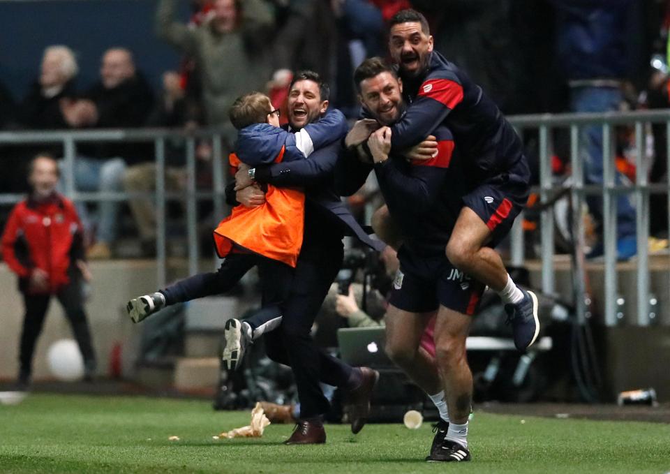  Lee Johnson produces a brilliant footballing image by celebrating with ball boy