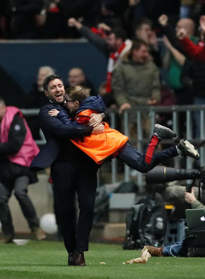  A jubilant Lee Johnson spins ball boy around in mid-air after late winner