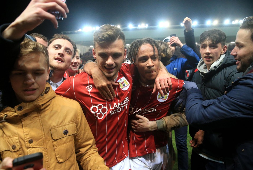 Bristol City players are surrounded by their adoring fans at Ashton Gate