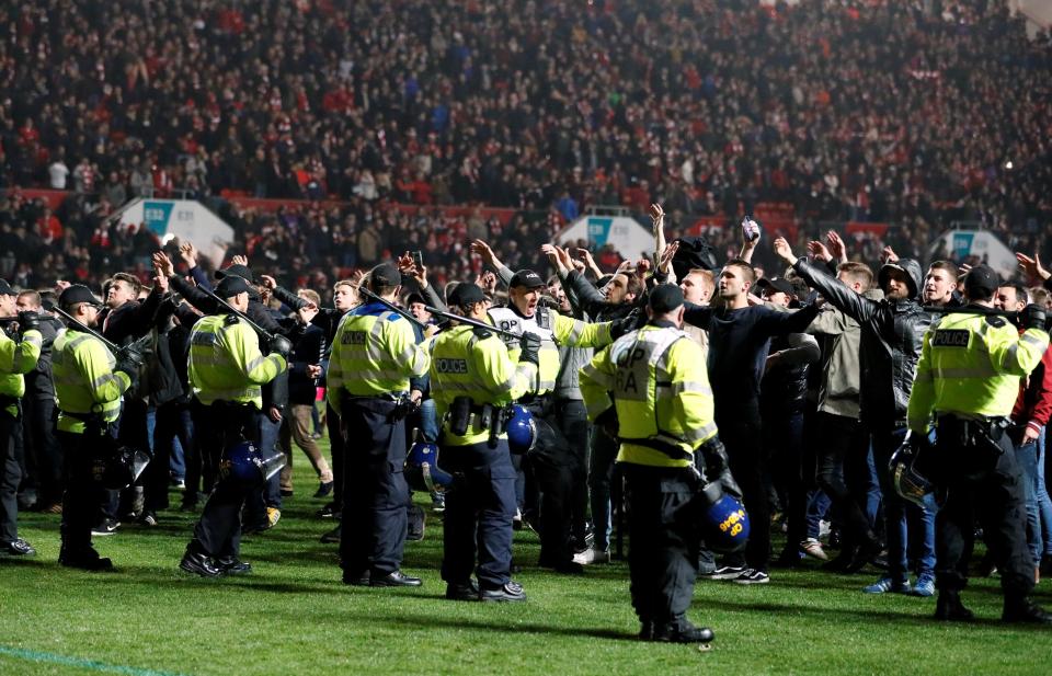  Police take to the pitch to try and maintain calm despite the momentous result