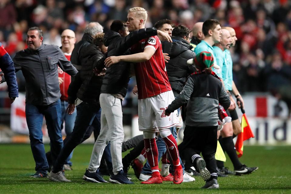  Some Bristol City players were happy to hug the pitch-invading supporters