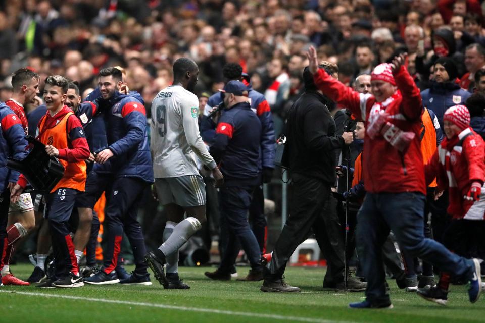  Manchester United striker Romelu Lukaku walks past Bristol City's celebrating fans