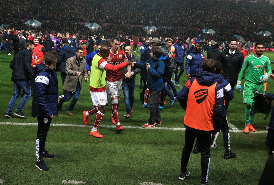 Thousands of fans rushed onto the pitch to celebrate together