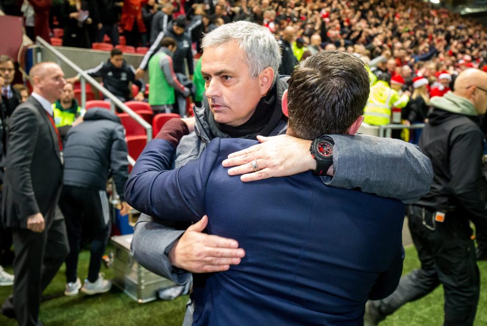  Jose Mourinho embraces Bristol City boss Lee Johnson after cup defeat