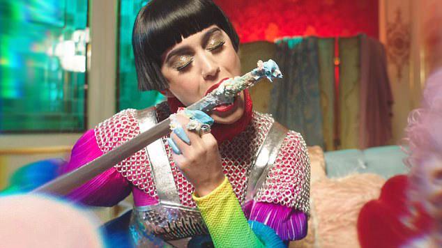 Joan is seen licking cake off her sword