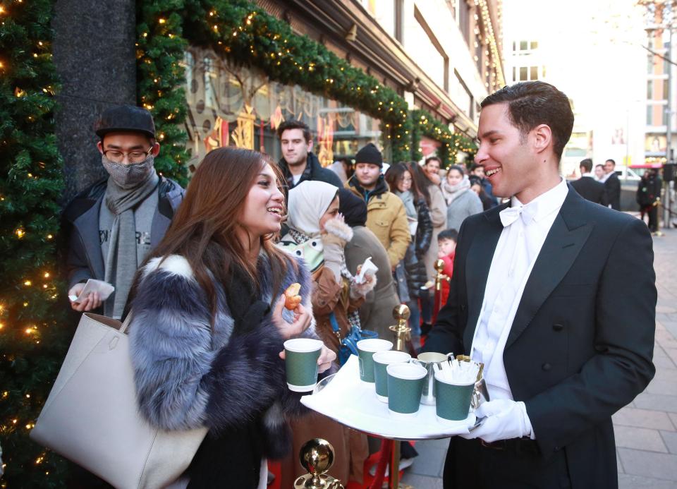  Butler serves drinks to dozens waiting outside posh London store Harrods