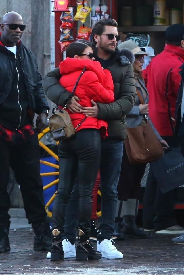  Sofia cuddles Scott as they stand by a street vendor