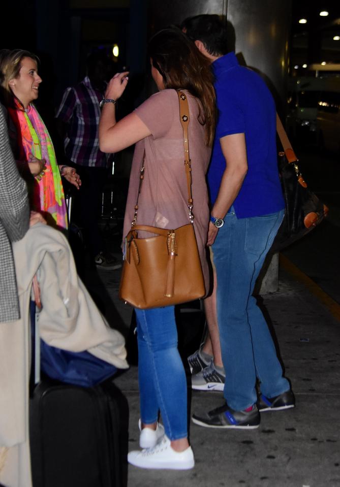  She looked to be sharing a laugh with pals as they waited for cars to arrive for them at the airport