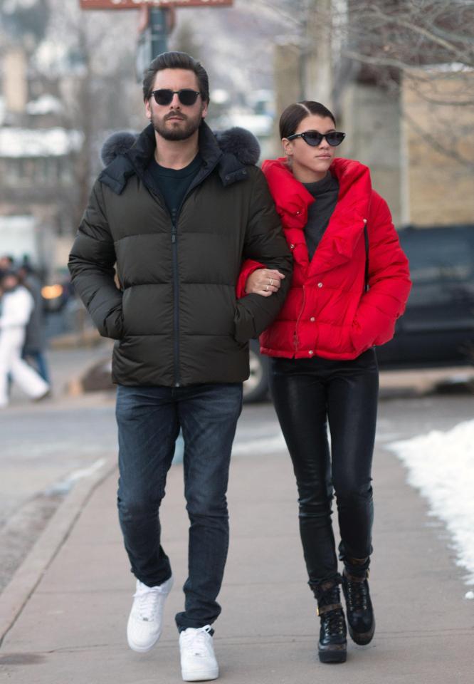  The couple stroll the snowy streets arm in arm