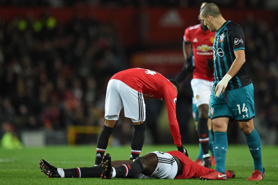  Jesse Lingard checks on his team-mate, who was left grounded by the collision