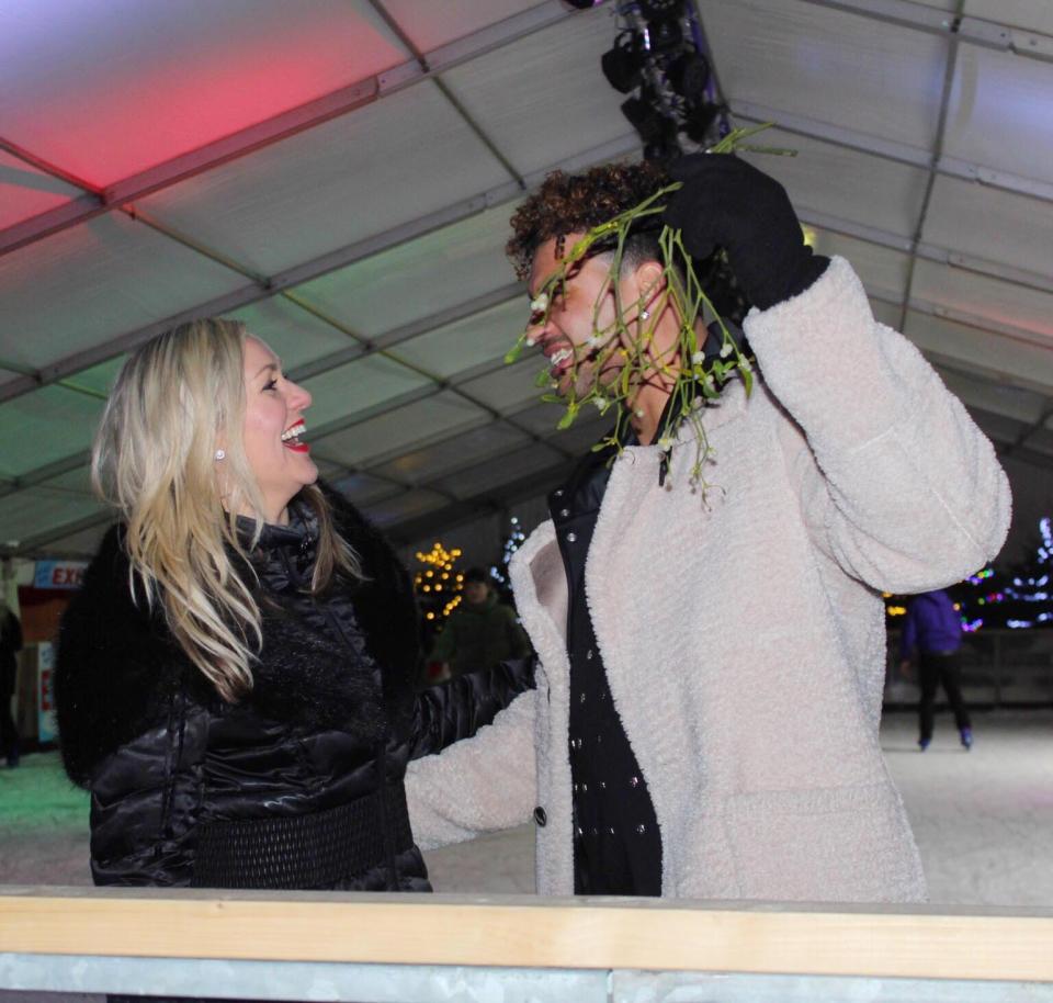  The singer asked for a peck under the mistletoe as they hit the farm's Bavarian Nights event