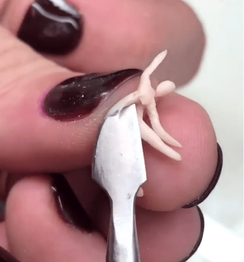 The technician skillfully creates a tiny stripper from acrylic 