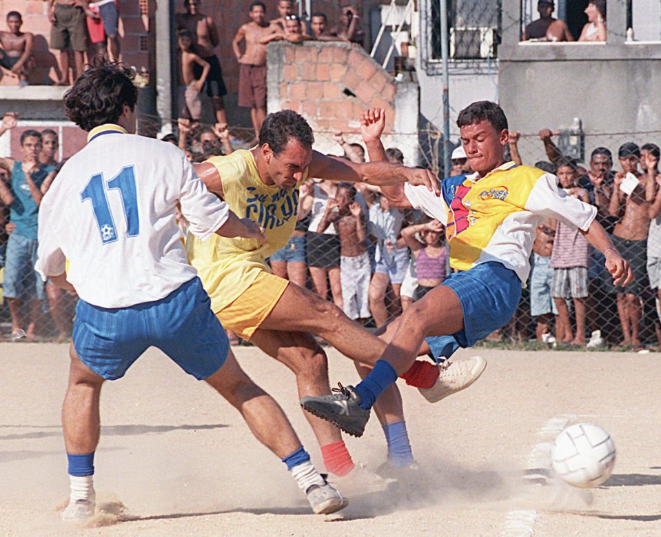  Edmundo and members of Brazil's 1998 World Cup squad play in a Rio favela