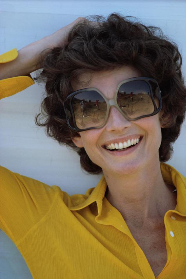  1975: Audrey looks fabulous at 46 and is pictured in huge sunglasses and a bright blouse