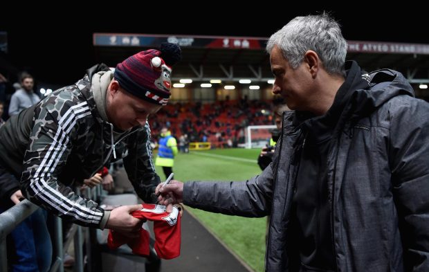 Jose Mourinho signs a fan's shirt before Manchester United's loss to Bristol City