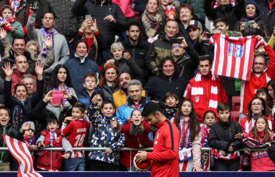  The Spain striker signs a ball as fans turn out for his unveiling