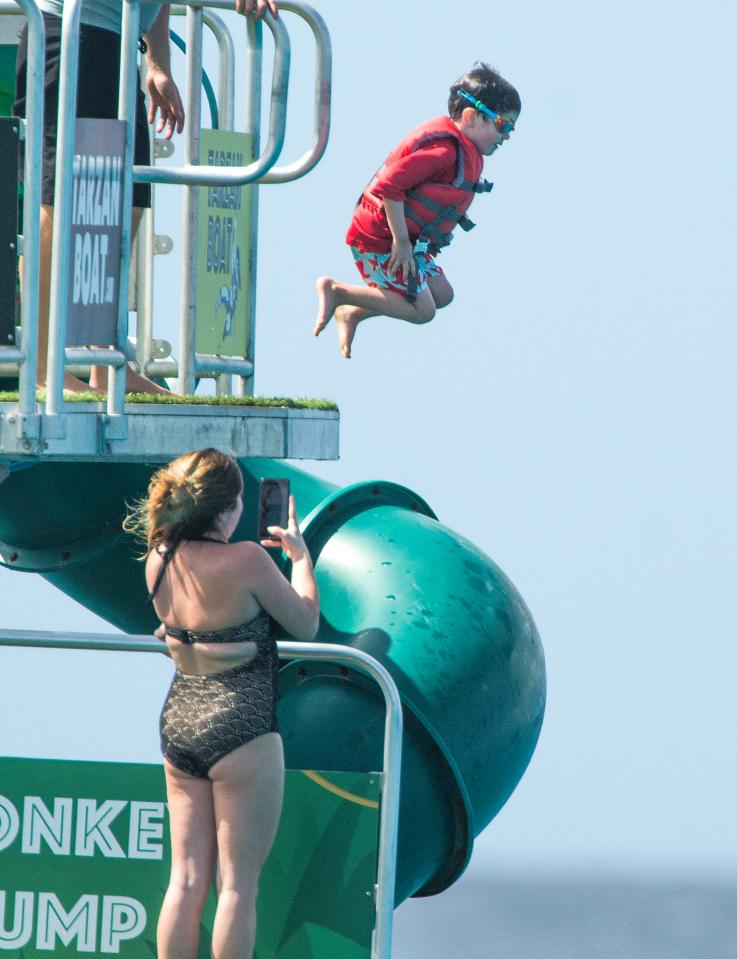  The brave three-year-old takes a plucky leap into the sea while on holiday