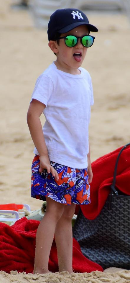  The cheeky lad sticks out his tongue while sunning it up on the dream holiday island