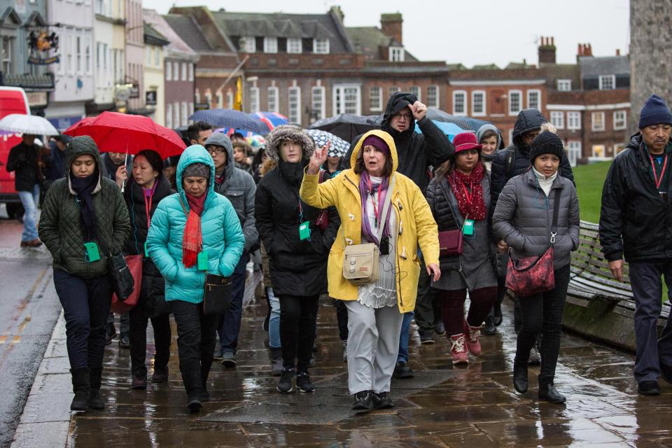  Tourists with rainwear and umbrellas brave the rain to visit Windsor Castle yesterday