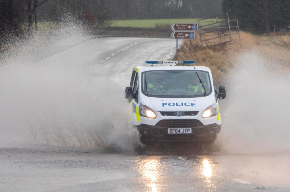  A police van drives through floodwater today in Linlithgow, West Lothian