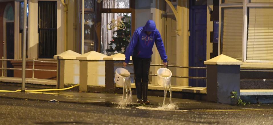  Residents and business owners were left using buckets to bail out