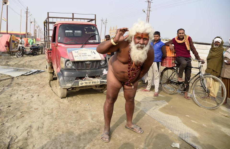  The naked holy man tows a lorry up the road using his willy