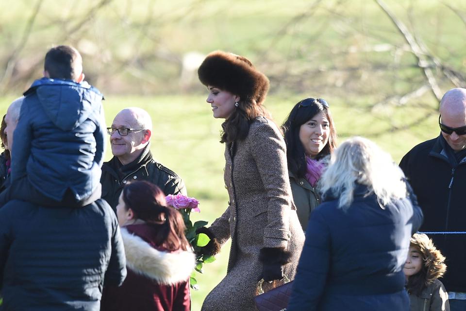  The Duchess of Cambridge showcased her growing baby bump in a large brown coat this morning as she walked to a Sandringham church service