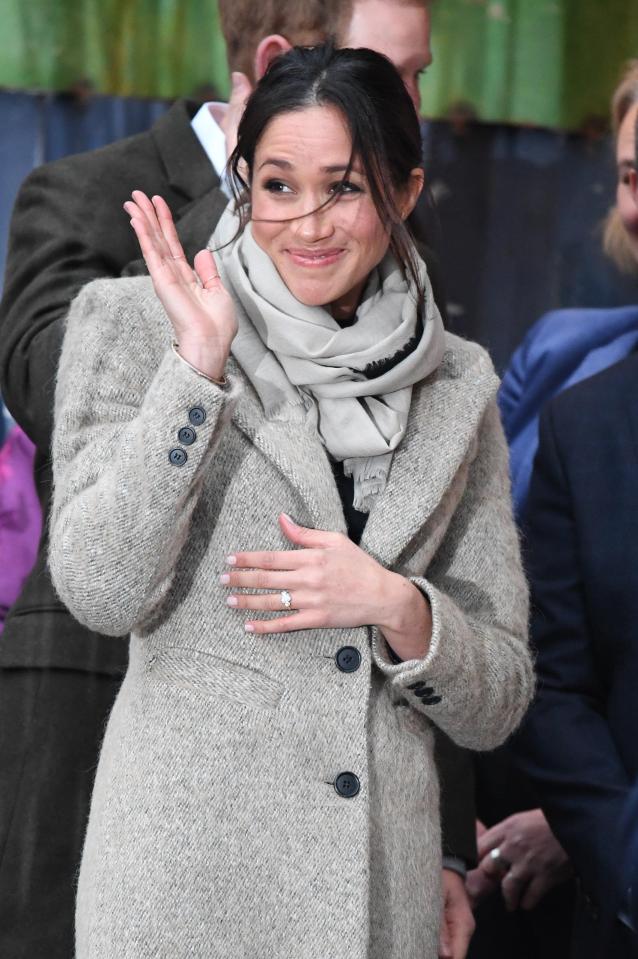  Meghan smiles cheekily as she arrives for the visit to Brixton - dazzling crowds with her ring