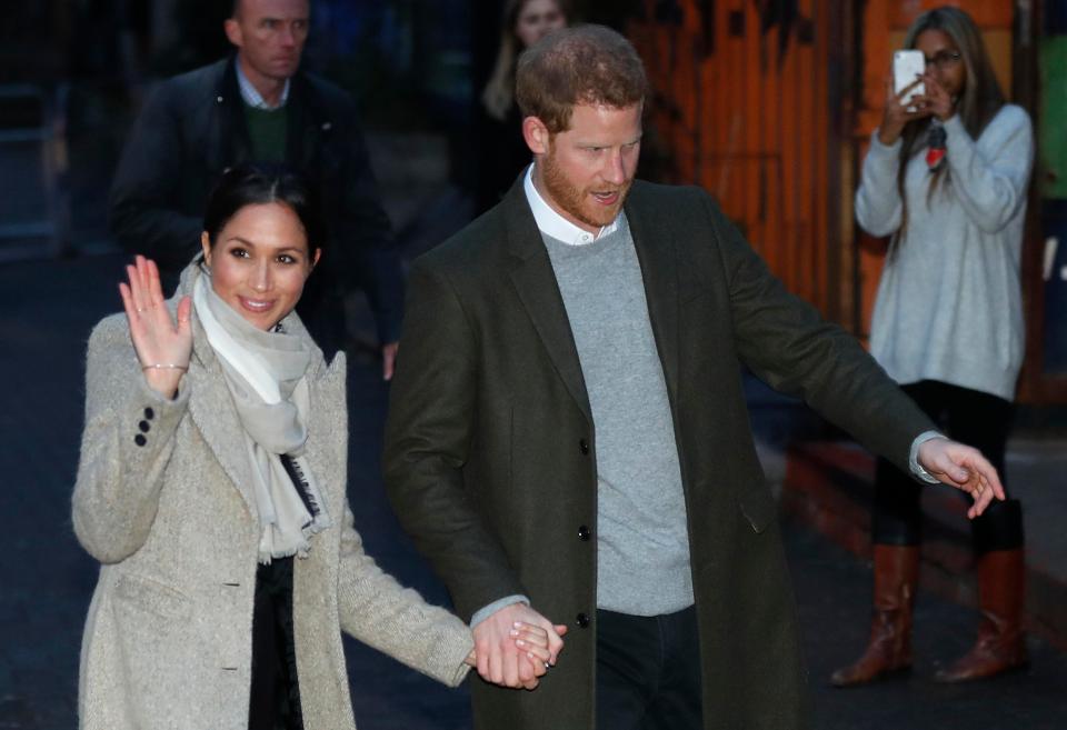  Harry holds the hand of Meghan as they leave their first official event together for 2018