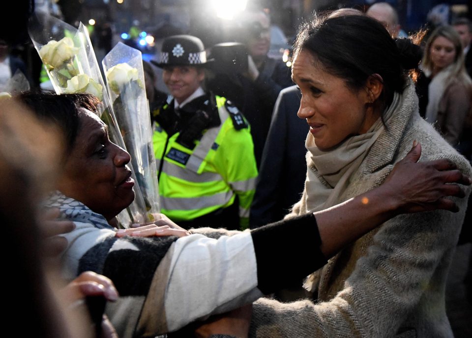  Meghan Markle hugs a tearful well-wisher on her visit to Brixton youth radio station Reprezent FM with Prince Harry