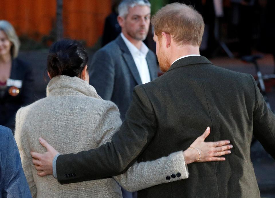  Meghan and Harry put their arms around each other as they left the event