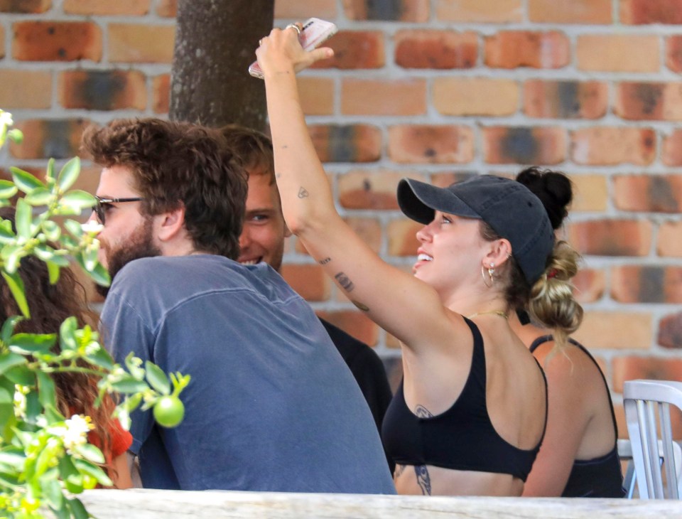 Miley was seen taking a selfie - or checking for phone reception