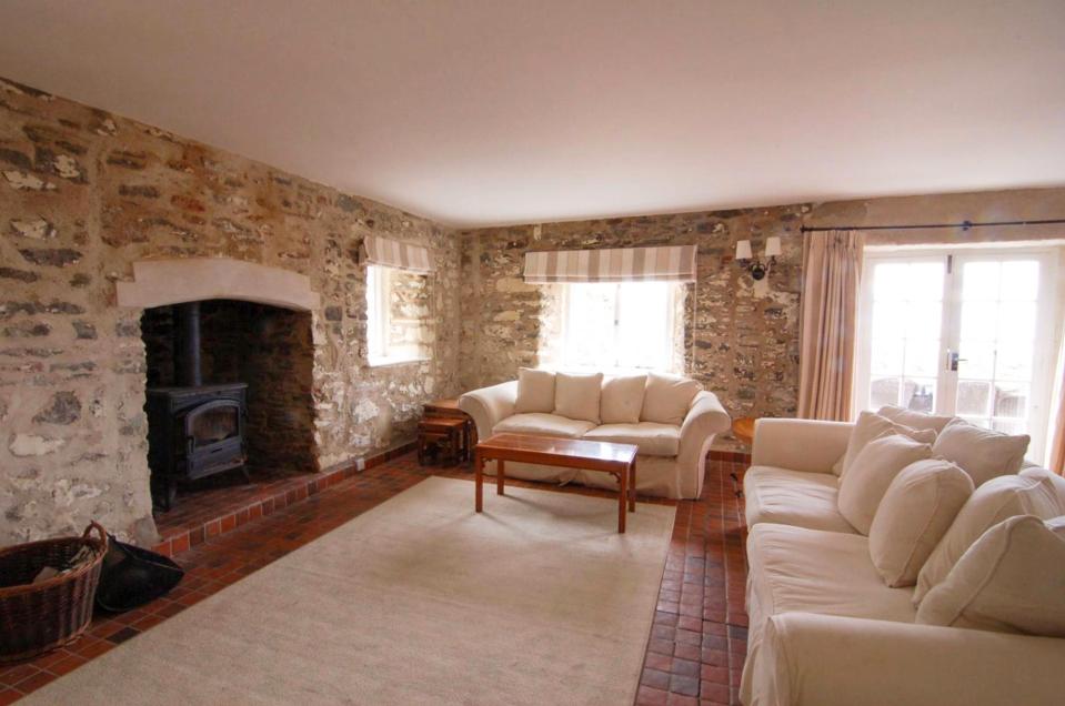  The living room is fitted with a feature fireplace and log burner