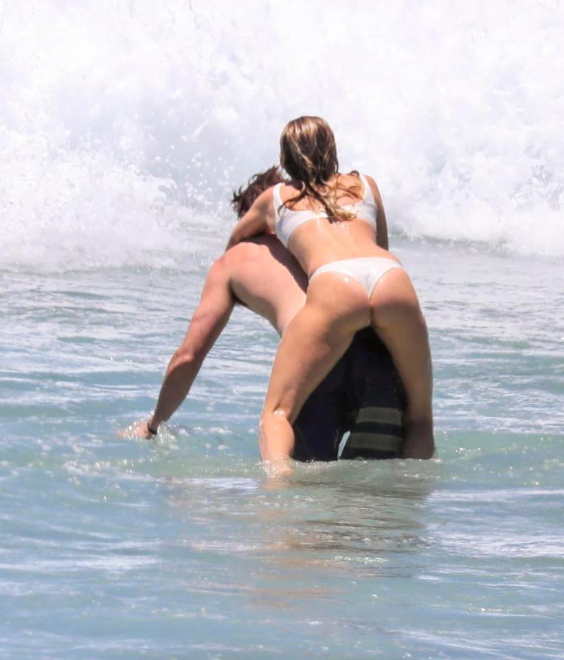  Miley climbed on her fiance's back at one point