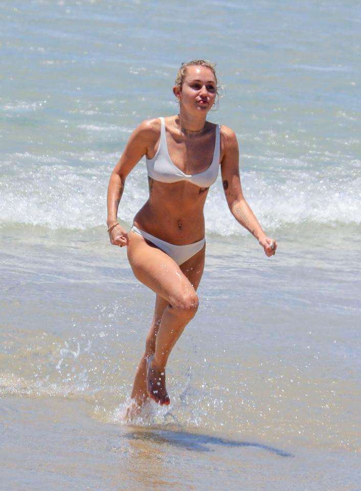  Miley Cyrus showed off her impressive figure in a white bikini while in Australia