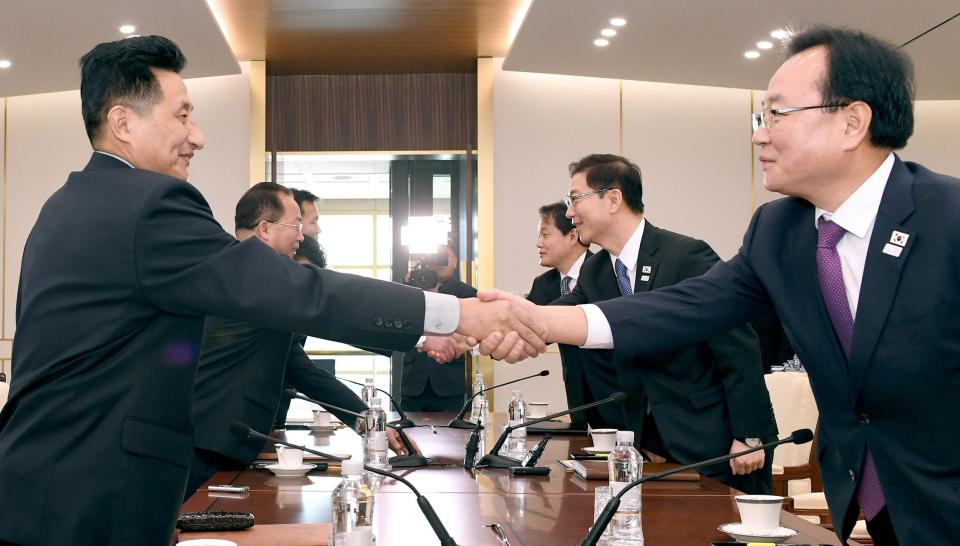  North and South Korean diplomats shake hands during cross-border talks