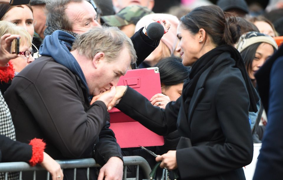  HAND KISSES . . . Meghan let one fan plant a kiss on her hand