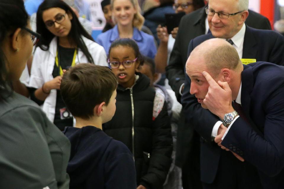  Prince William points out his new haircut to interested school kids