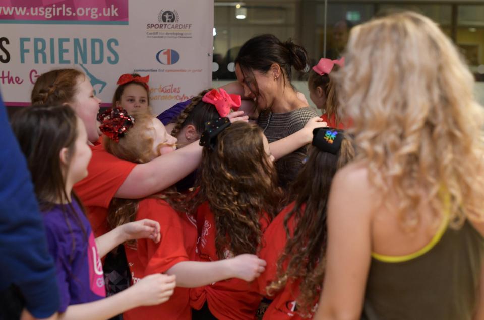  HUGS . . . Meghan was mobbed and embraced by gleeful schoolkids at Star Hub