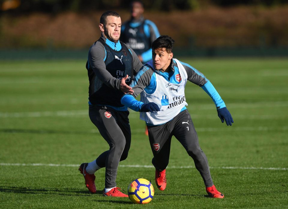  Jack Wilshere attempts to win the ball off Sanchez