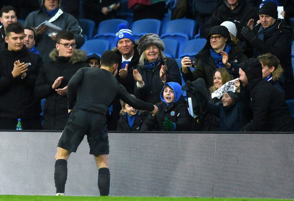  Eden Hazard hands over his shirt to a delighted young fan at Brighton