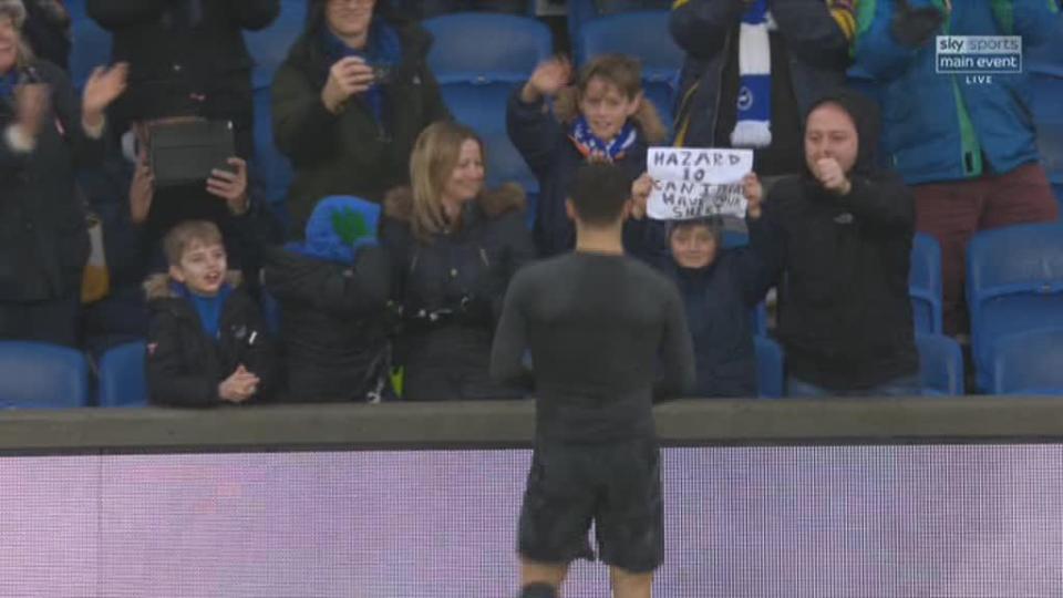  Hazard approaches the youngster waving his sign asking for the shirt